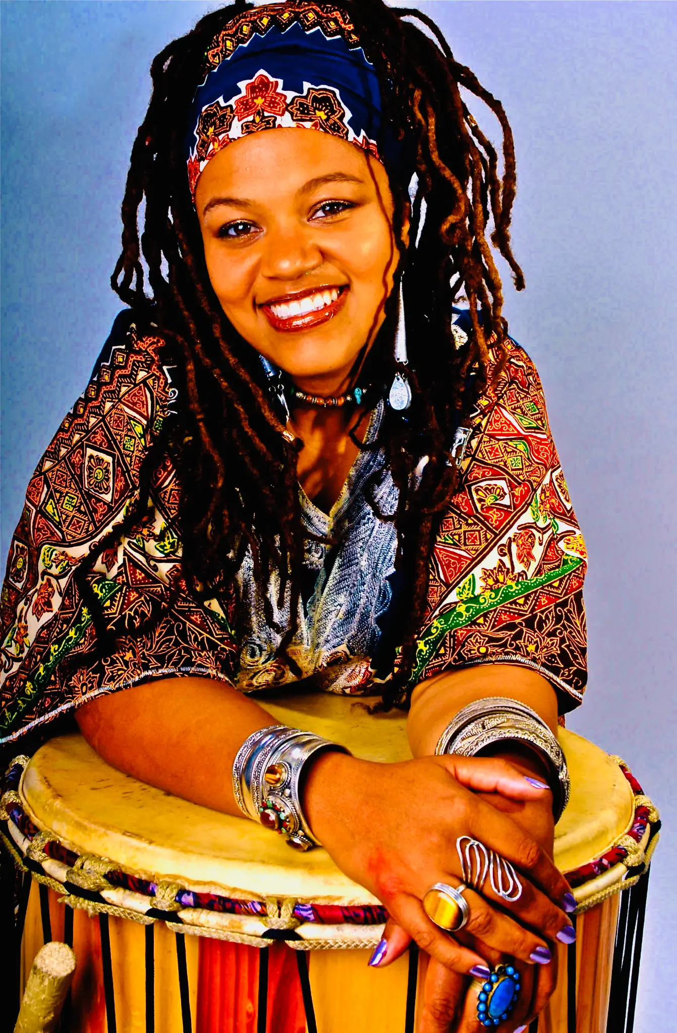 Amikaeyla with drum, colorful traditional attire